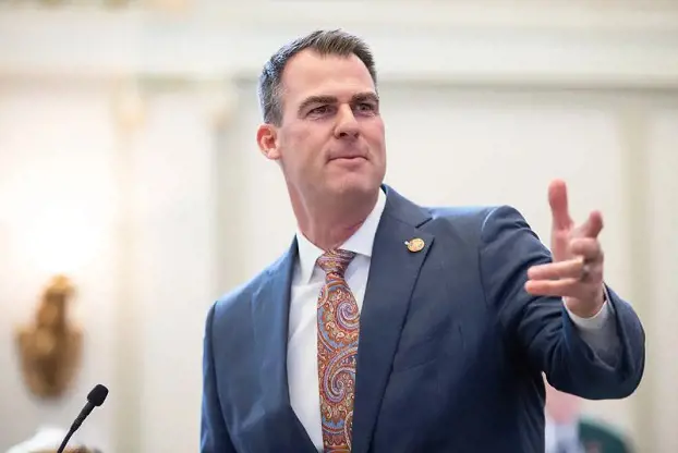 Oklahoma Gov. Kevin Stitt gestures toward his cabinet members during his fourth State of the State address at the Capitol on Feb. 7, 2022