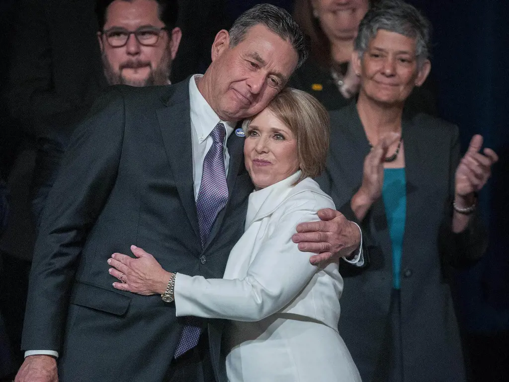 Manuel Cordova hugs Michelle Lujan Grisham after she gave her inaugural address during her inaugural ceremony in Santa Fe on January 1, 2019.