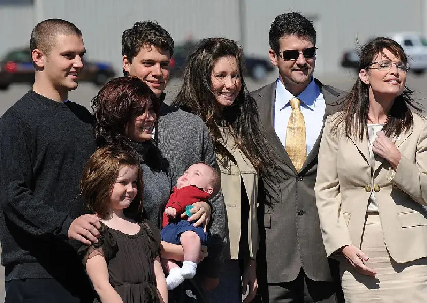 Todd Palin and Sarah Palin stands together with their family