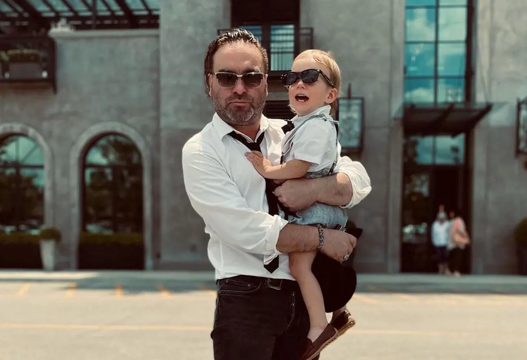 Johnny with his son Avery wearing sunglasses
